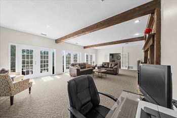 A room with a black chair and a computer desk.